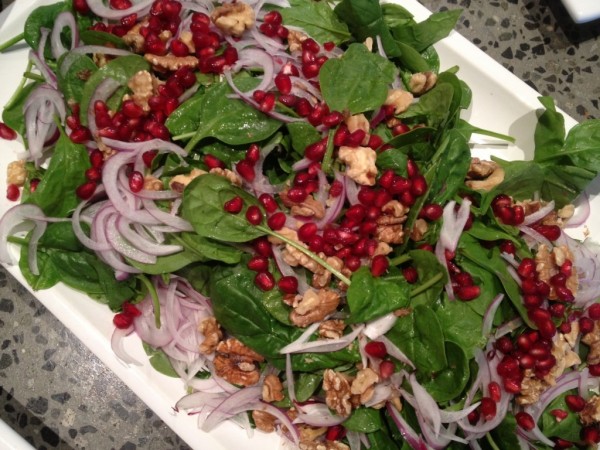 Salad of baby spinach, Spanish onion, toasted walnuts and pomegranate seeds