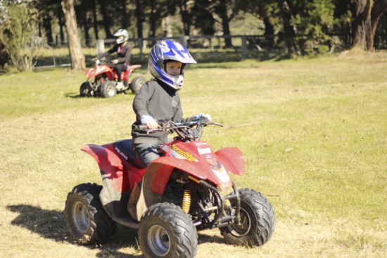 Alfie on the quad bike with the 'senior' in the background.