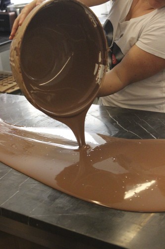 Pouring the milk chocolate onto the marble