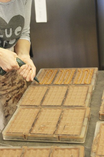Rebecca squeezing the caramel into the chocolate molds