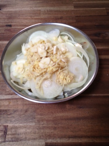 Sliced onions, grated ginger and sliced garlic