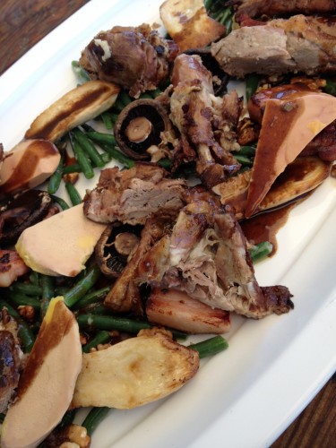 The main course of green beans, confit goose legs, pancetta batons, mushrooms, foie gras and toasted walnuts