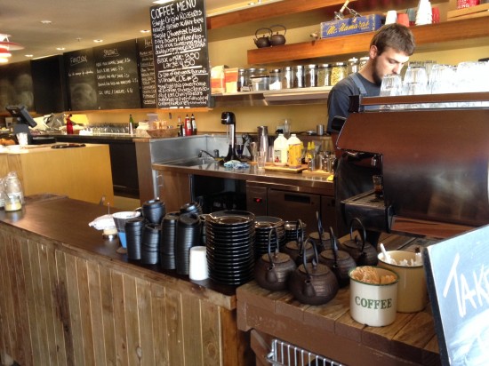 The coffee bar and the empty blackboards behind the counter