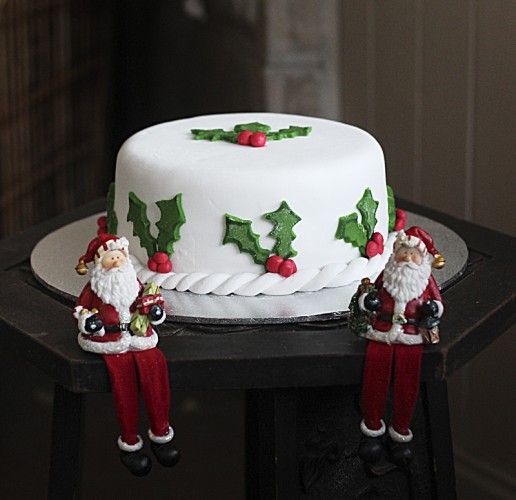 A Christmas cake decorated with holly