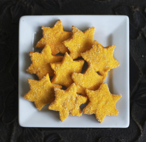 Christmas Stars iced in yellow icing then dipped in yellow sparkle sugar