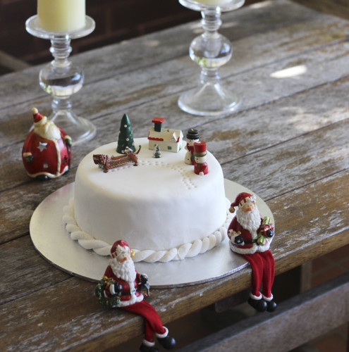 A Christmas cake covered in marzipan then white fondant