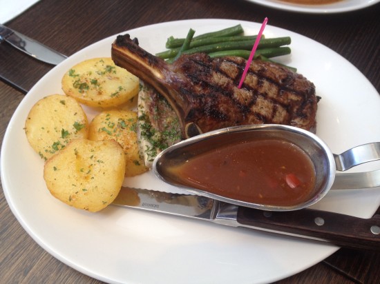 Dry aged rib eye on the bone 400gms served with roasted bone marrow, roasted potatoes and green beans $42.00.  