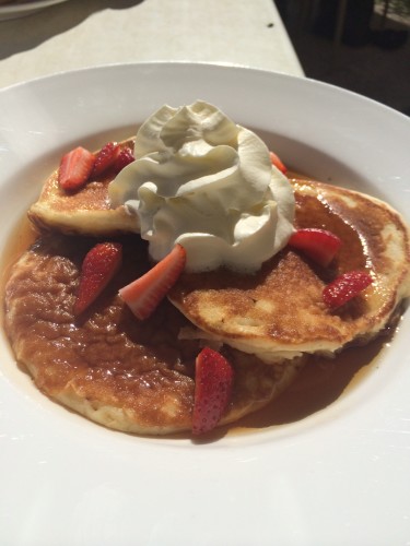 Pancakes with maple syrup, whipped cream and strawberries:  $10.00