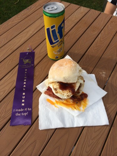 A runner's ribbon, a sugary drink and my bacon and egg roll with the yolk on the napkin rather than the roll