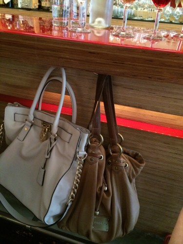 I love how there are hooks under the bar to hang your 'oversized, overpriced designer handbag' 