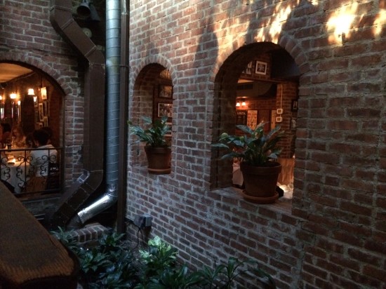 Through the archways you can see the courtyard with trees covered in fairy lights
