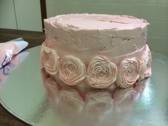 Start by piping roses around the bottom of the cake