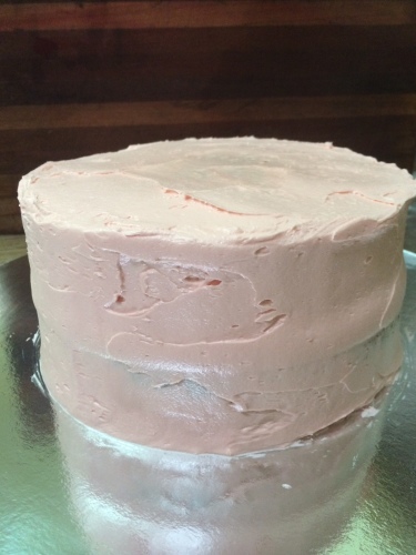 Cover cake in a layer of frosting.  