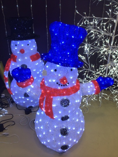 Snowmen lit up like Christmas trees