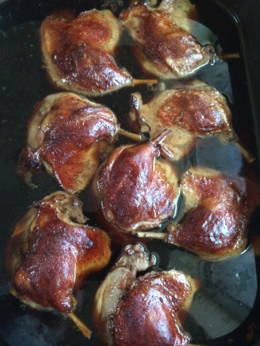 Confit duck legs cooking in a Thai master stock