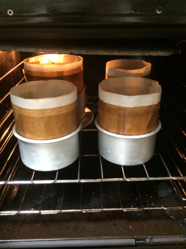 Four Christmas cakes entering the oven 
