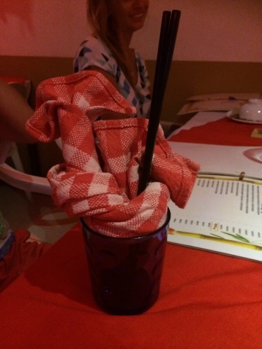 Tea-towel napkins twisted into water glasses