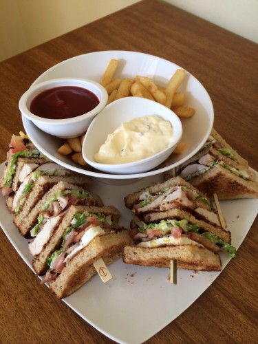 Club sandwich with fries with sauce and aioli 