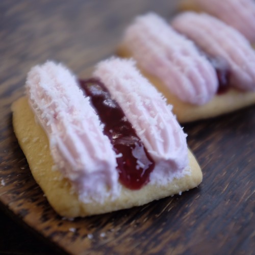 Marshmallow, coconut and raspberry jam on a biscuit