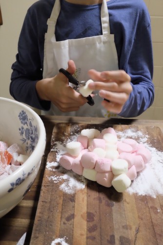 Chopping the marshmallows with scissors