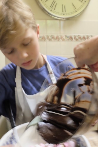 Pouring the chocolate into the nut mixture 