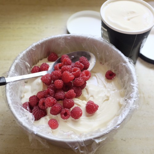 Add ice cream and spoon through the raspberries 